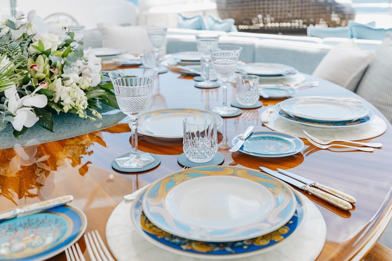 a table set with plates and glasses aboard LADY B Yacht for Sale