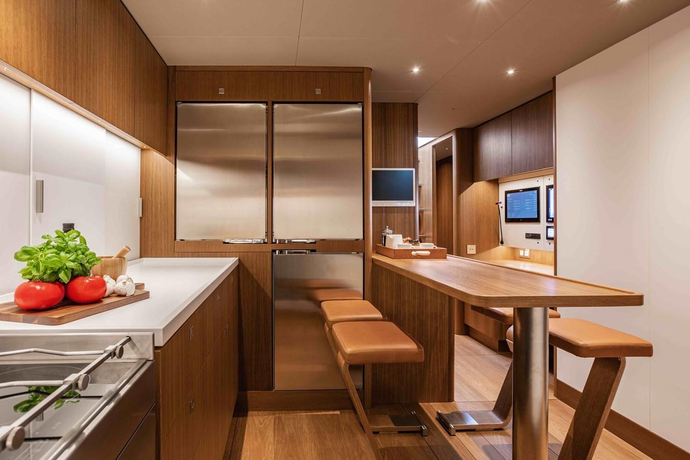 a kitchen with a table and chairs aboard HONEY RYDER Yacht for Sale