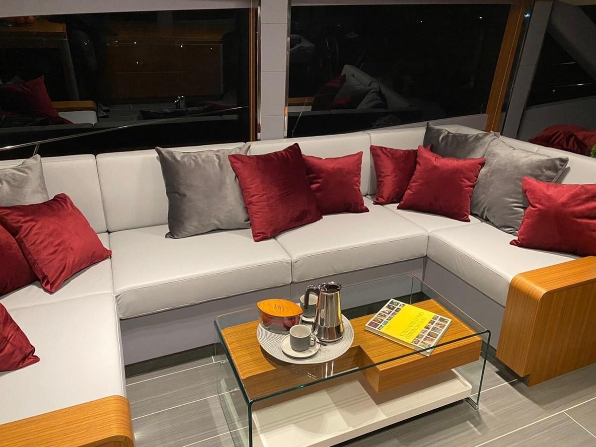 a white couch with red pillows aboard OCEAN CLASS 68 Yacht for Sale