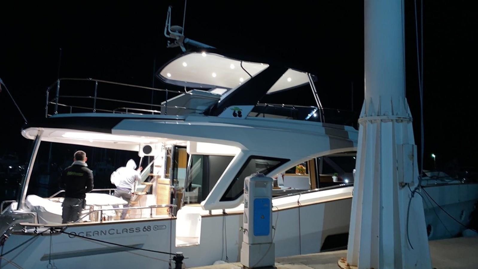 a boat with a couple of people inside aboard OCEAN CLASS 68 Yacht for Sale
