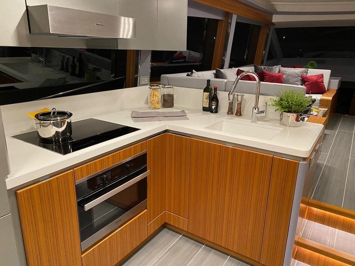 a kitchen with a sink and stove aboard OCEAN CLASS 68 Yacht for Sale