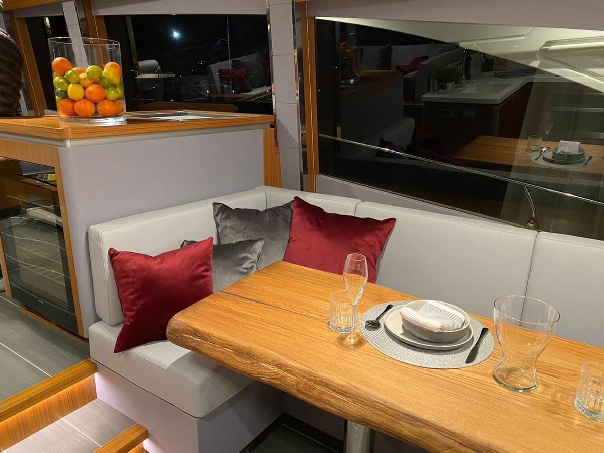 a table with plates and glasses on it aboard OCEAN CLASS 68 Yacht for Sale