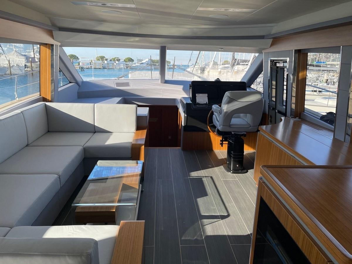 a room with a couch and a table aboard OCEAN CLASS 68 Yacht for Sale