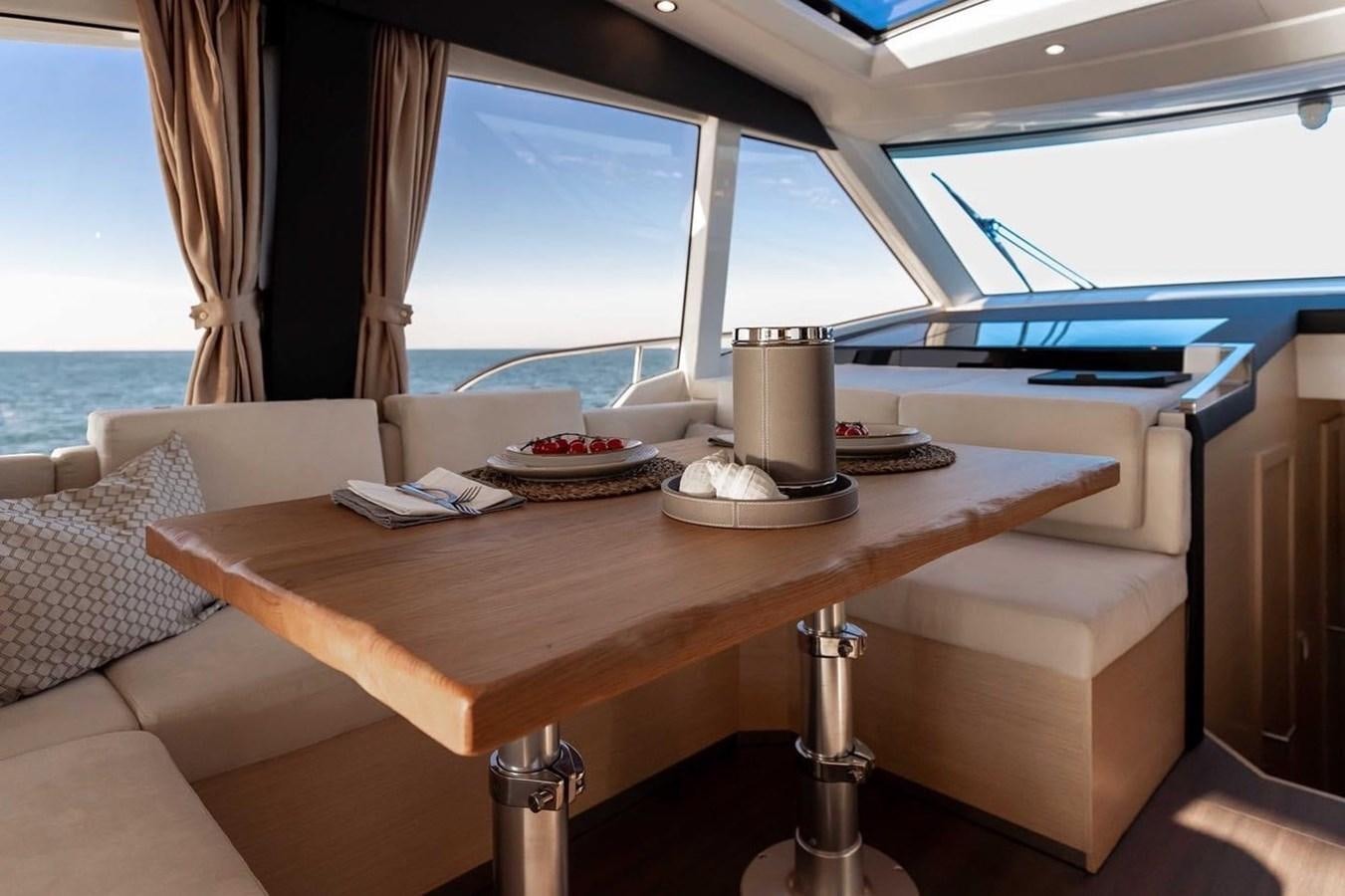 a table with a lamp on it aboard OCEAN CLASS 68 Yacht for Sale