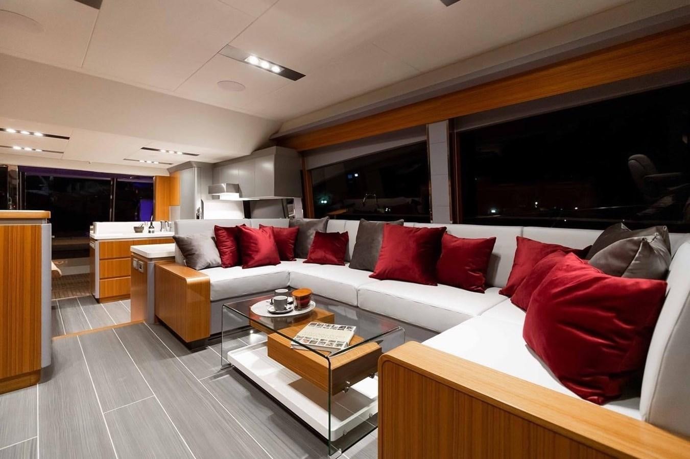 a living room with a large screen aboard OCEAN CLASS 68 Yacht for Sale