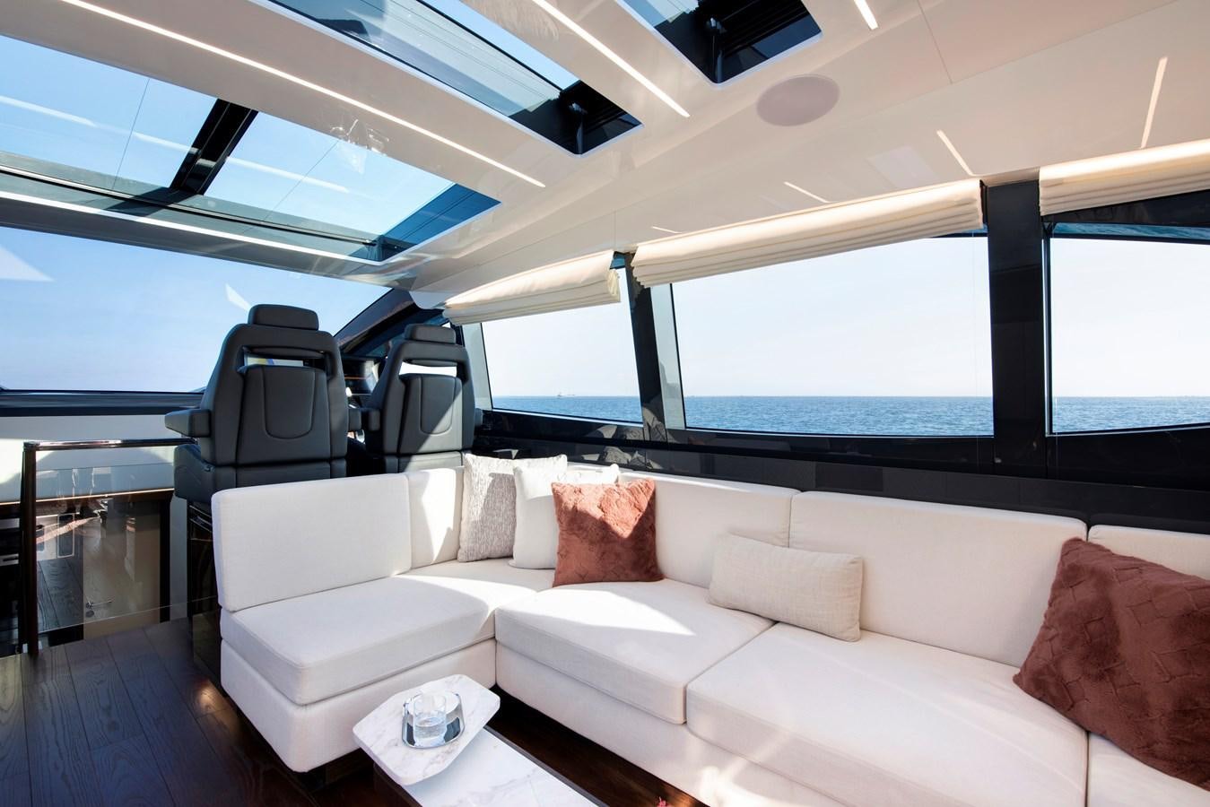 a room with a couch and a chair aboard LSX 67 SPORT EXPRESS Yacht for Sale