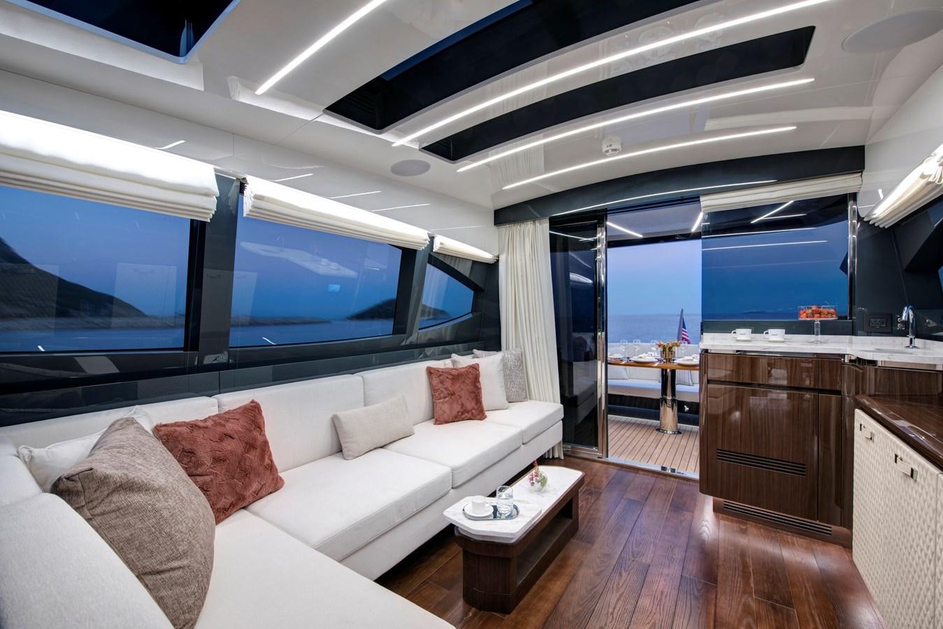 a living room with a large window aboard LSX 67 SPORT EXPRESS Yacht for Sale