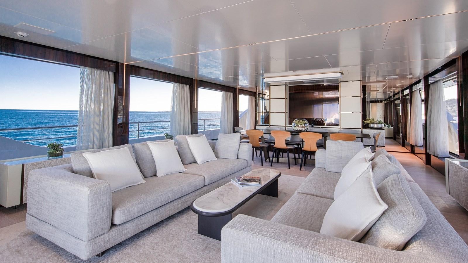 a living room with a large window aboard OCEANIC GRAND Yacht for Sale