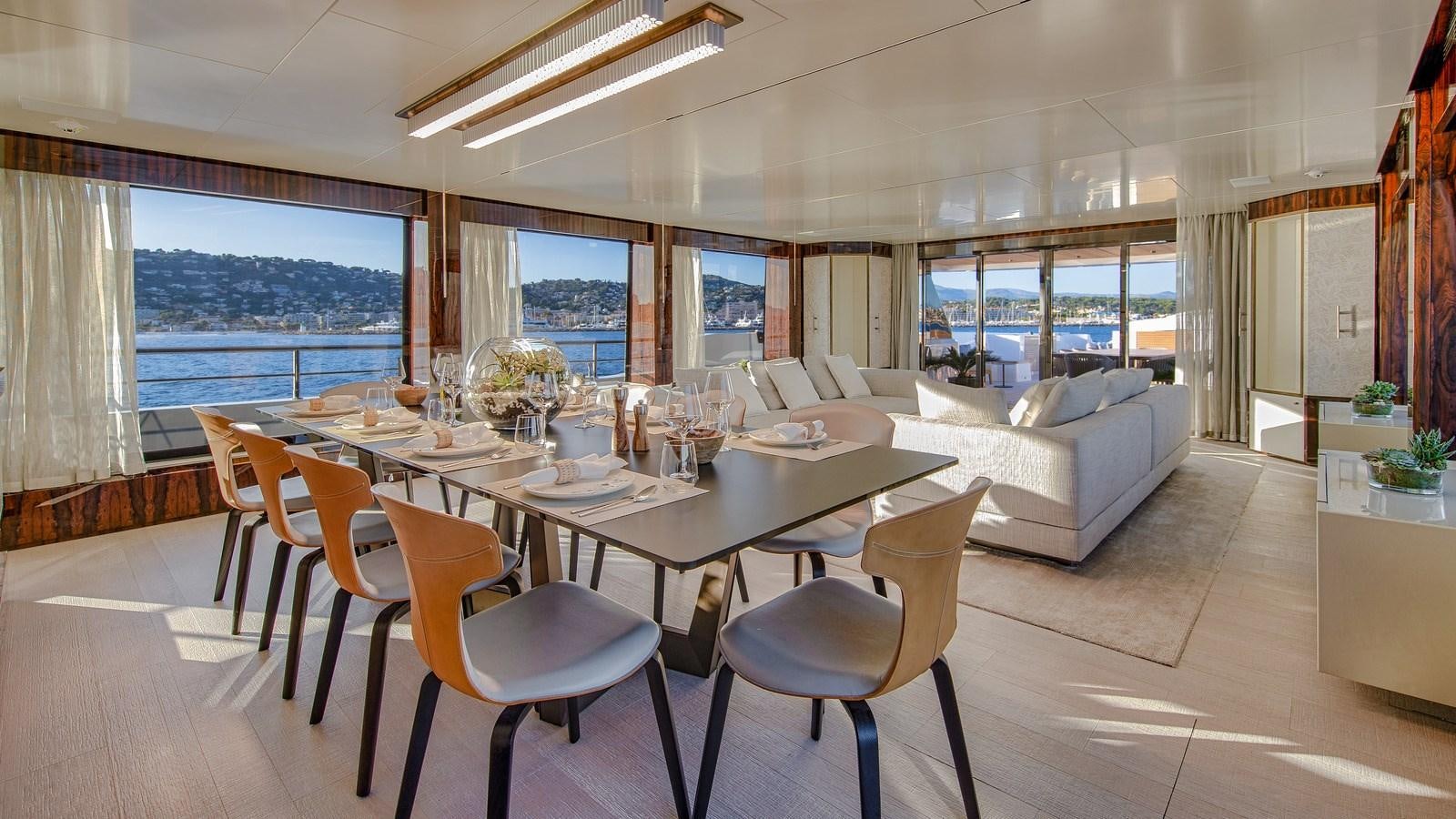 a large dining room with a large table and chairs aboard OCEANIC GRAND Yacht for Sale