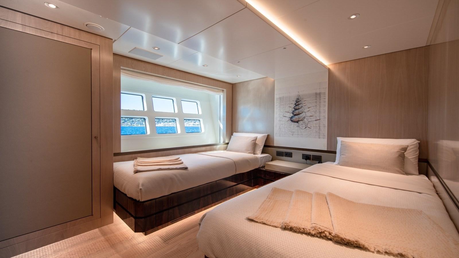 a room with a bed and a window aboard OCEANIC GRAND Yacht for Sale