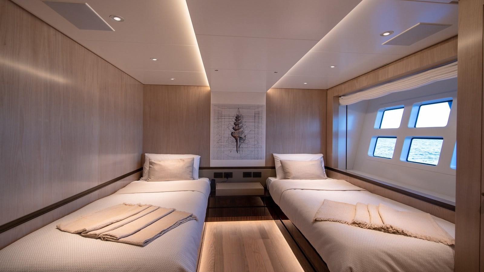 a room with a bed and a window aboard OCEANIC GRAND Yacht for Sale