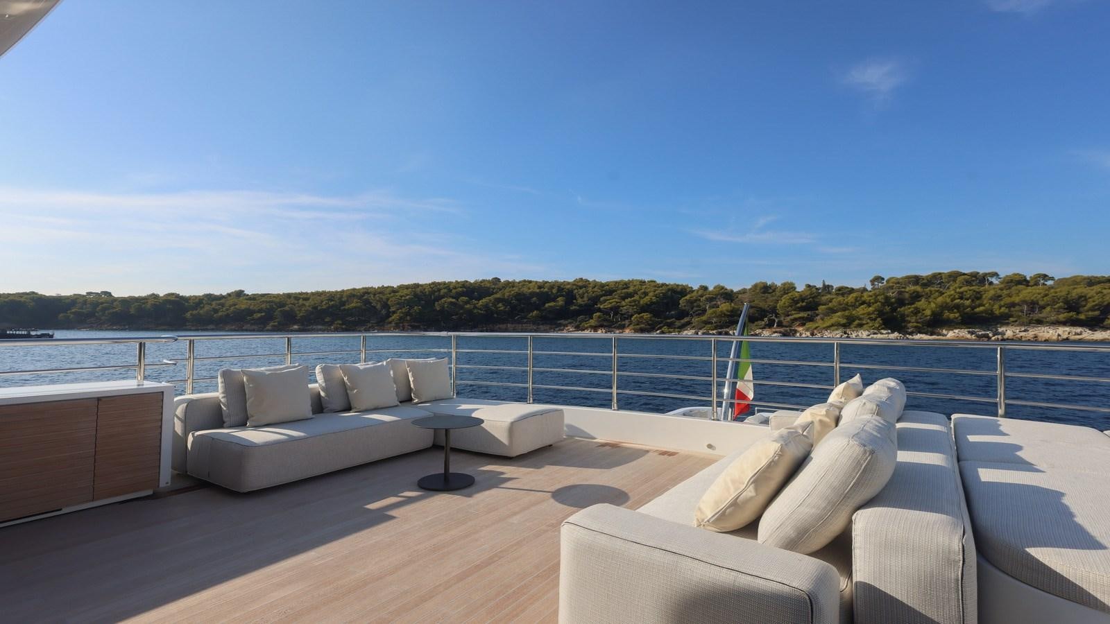 a patio with a couch and a pool aboard OCEANIC GRAND Yacht for Sale