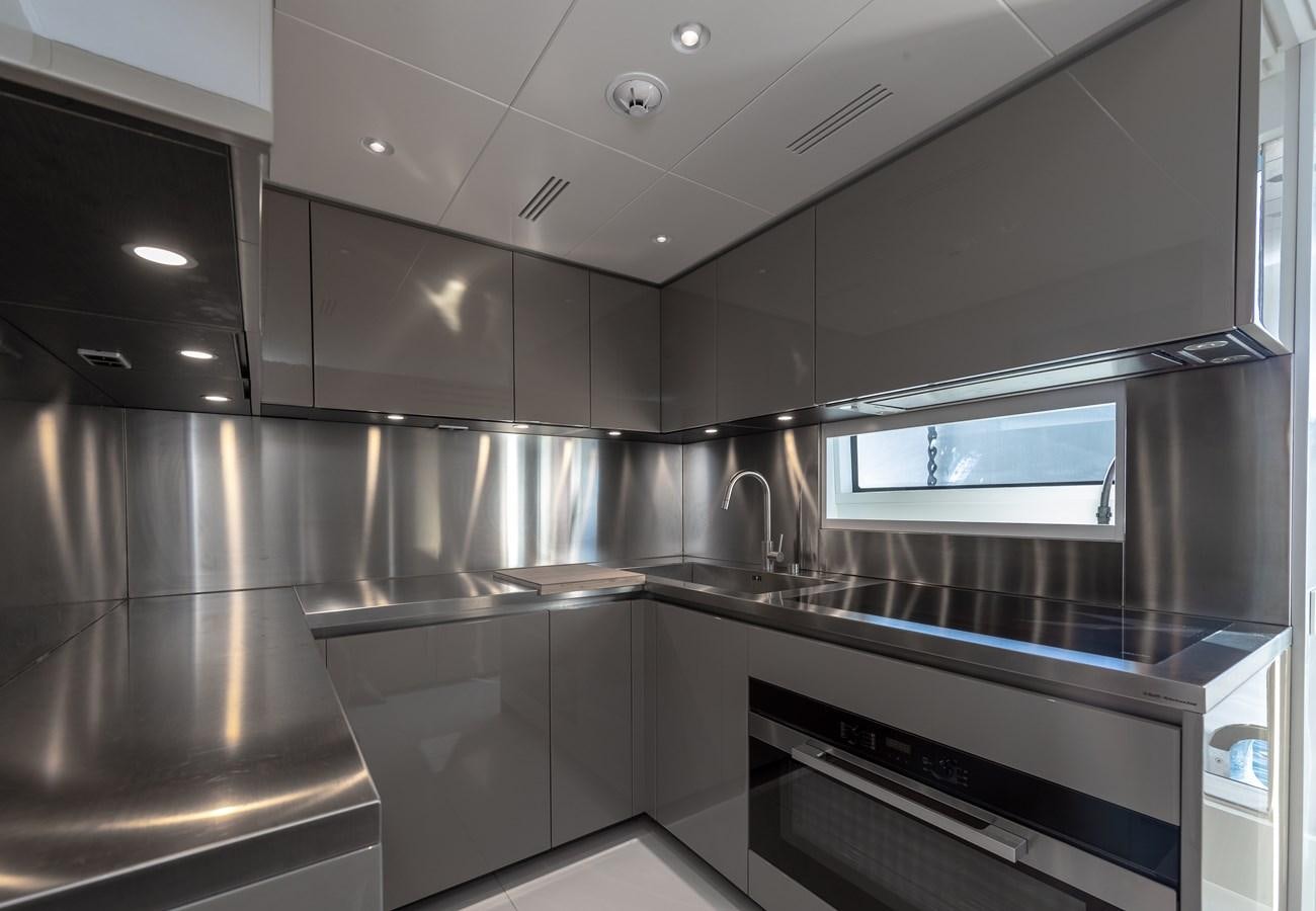 a kitchen with stainless steel appliances aboard OCEANIC GRAND Yacht for Sale