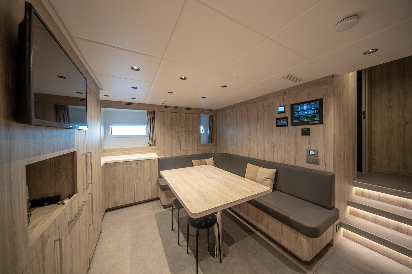 a room with a couch and a table aboard OCEANIC GRAND Yacht for Sale
