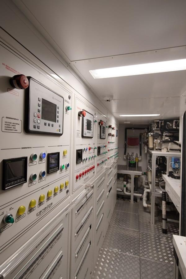 a room with white cabinets and electronic equipment aboard OCEANIC GRAND Yacht for Sale