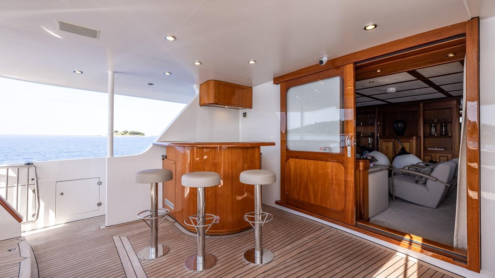 a room with a table chairs and a couch aboard SEA BREEZE II Yacht for Sale