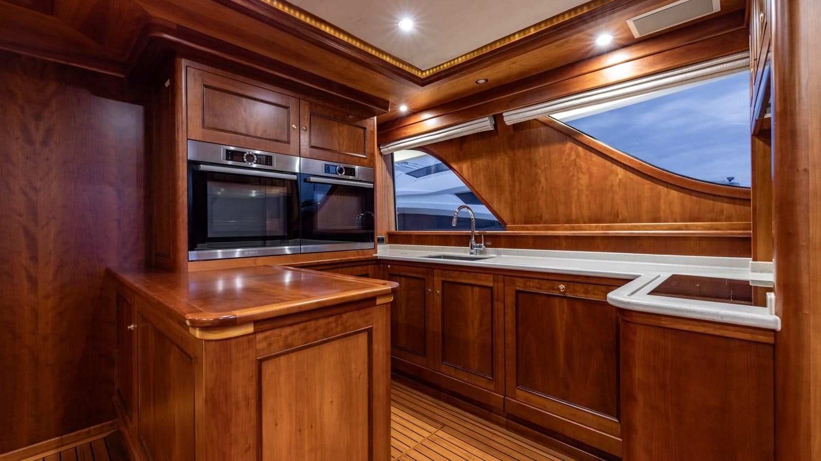 a kitchen with wooden cabinets aboard SEA BREEZE II Yacht for Sale