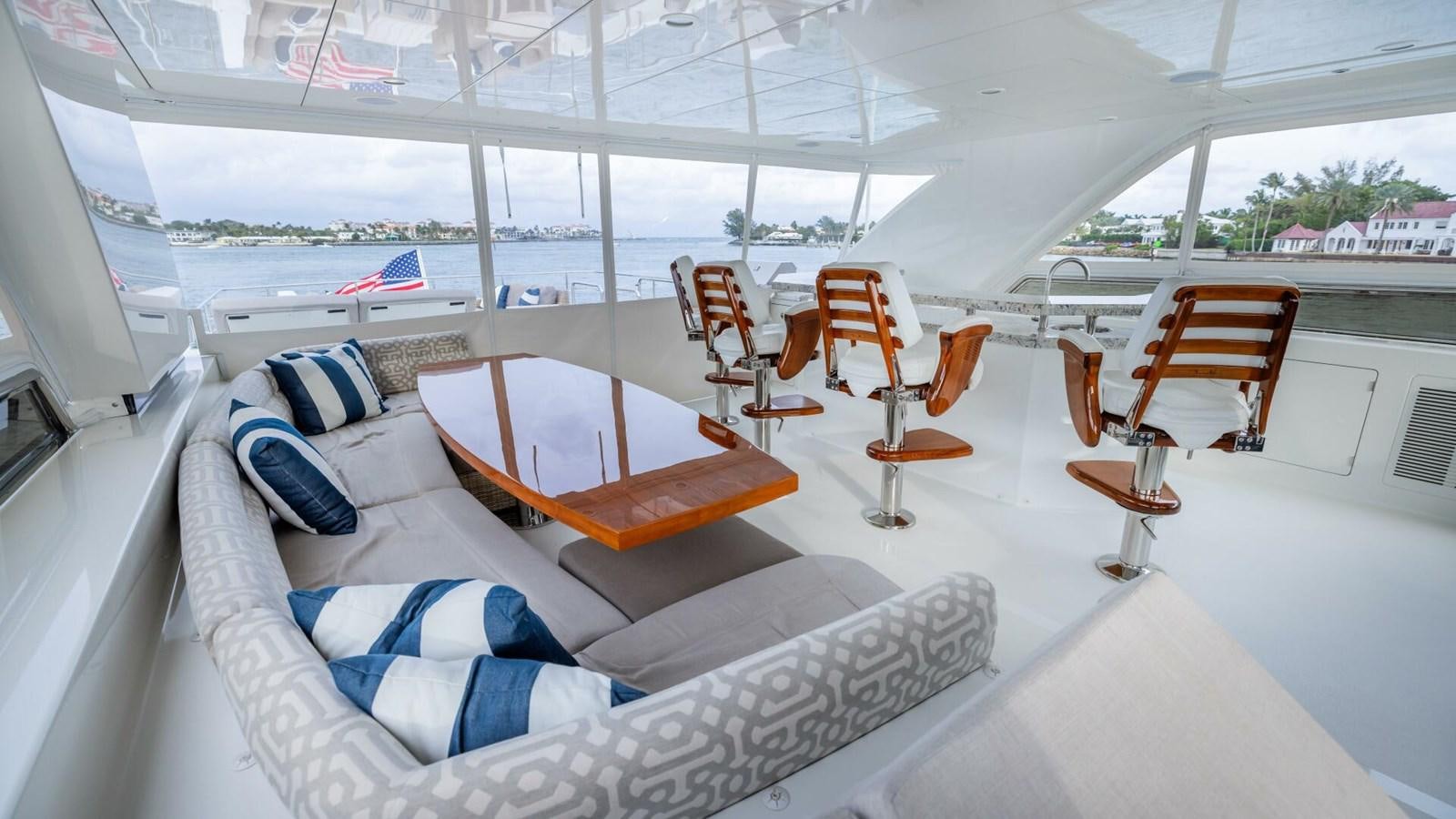 a room with a bed and chairs aboard CRUMDALE Yacht for Sale