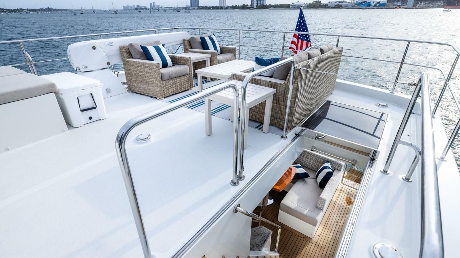a boat with a chair on the deck aboard CRUMDALE Yacht for Sale