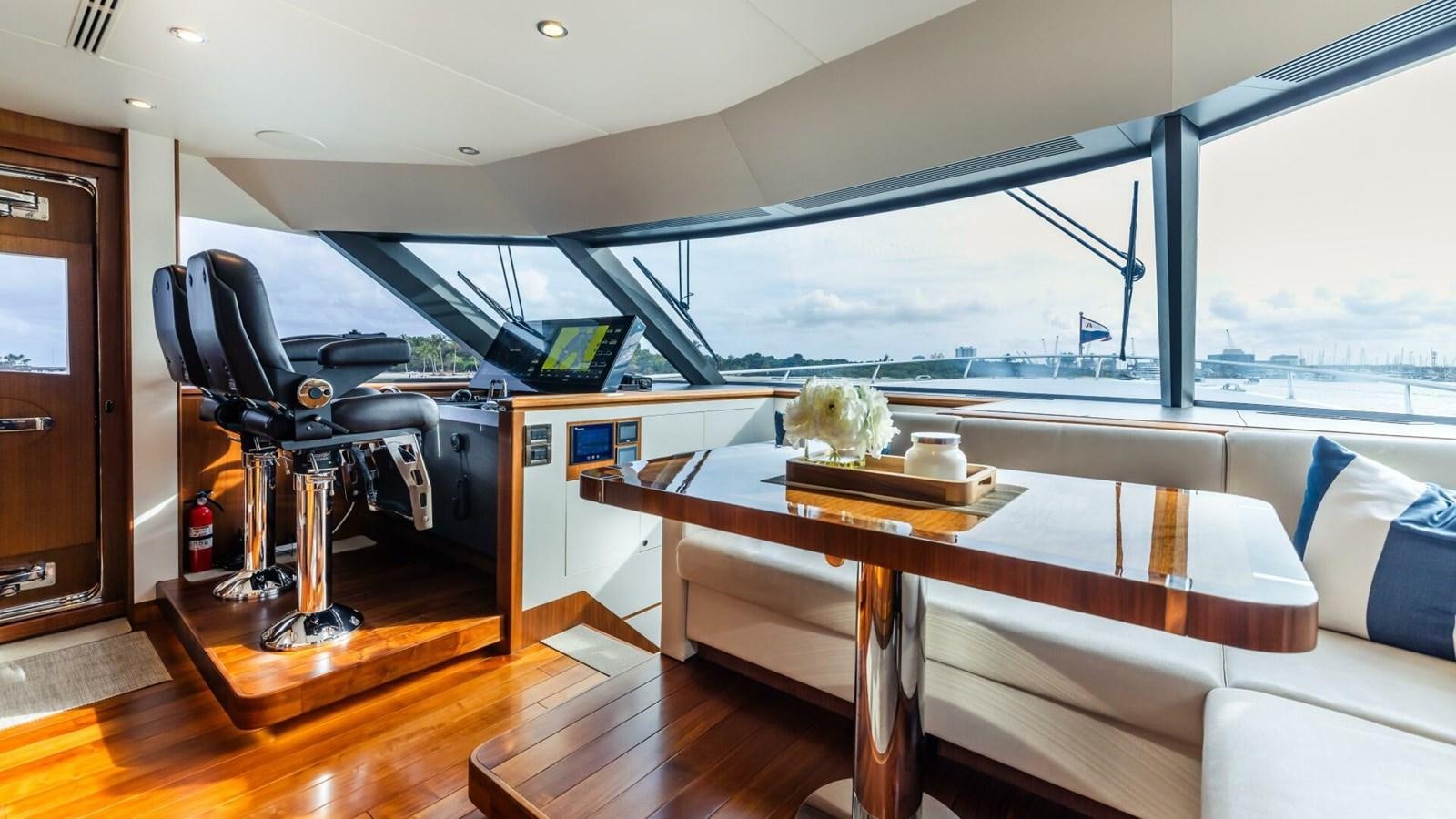 a room with a table and chairs aboard CRUMDALE Yacht for Sale