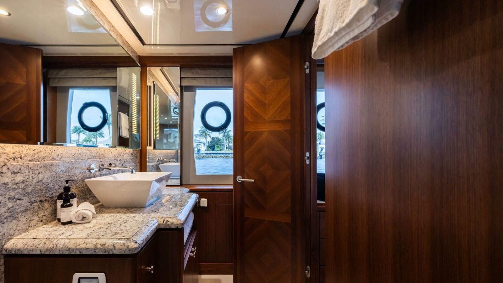 a bathroom with a sink and a mirror aboard CRUMDALE Yacht for Sale