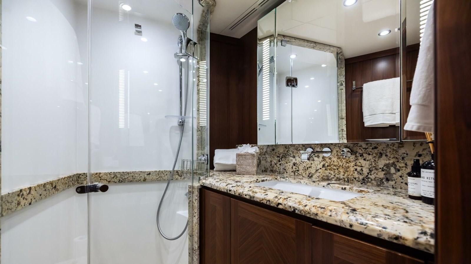 a bathroom with a large mirror aboard CRUMDALE Yacht for Sale