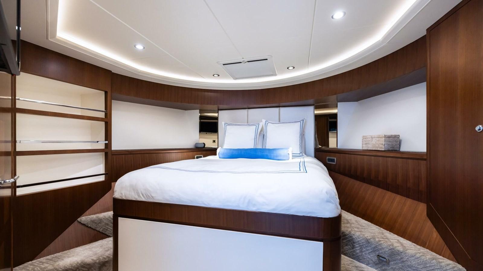 a room with a bed and a wood cabinet aboard CRUMDALE Yacht for Sale