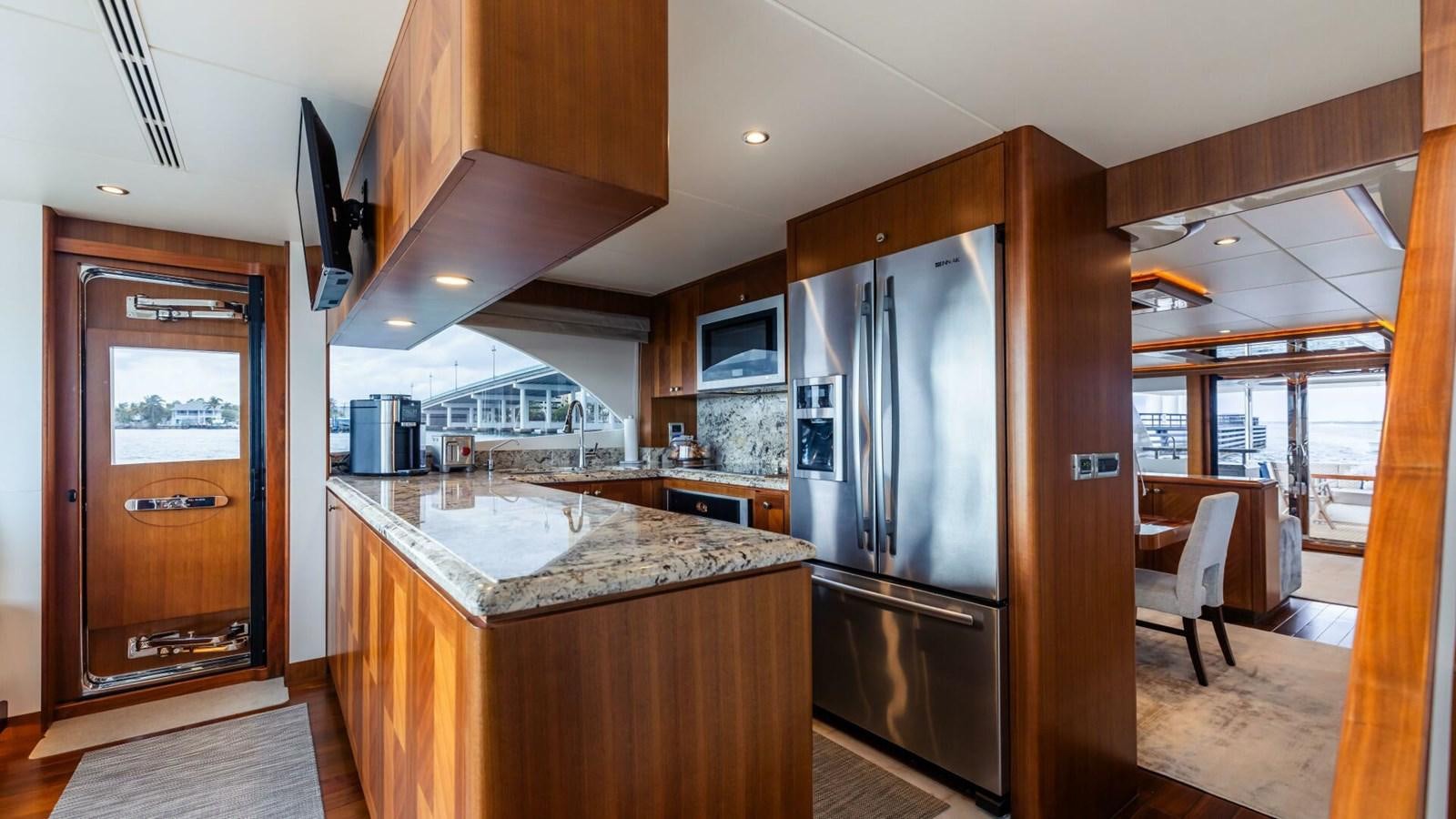 a kitchen with a large island aboard CRUMDALE Yacht for Sale