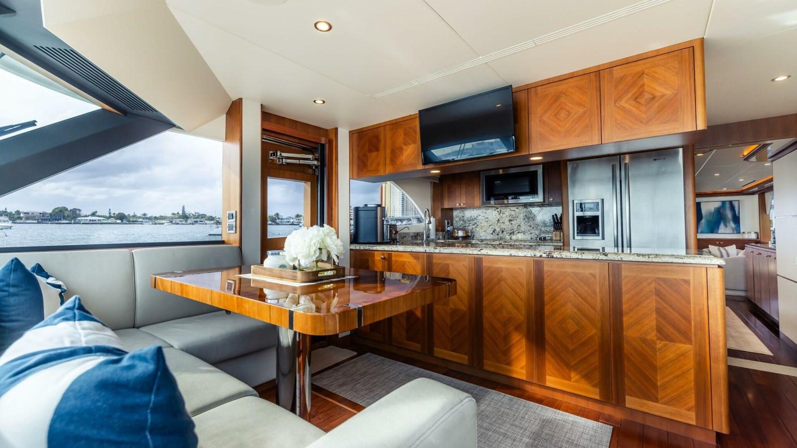 a kitchen with a large window aboard CRUMDALE Yacht for Sale