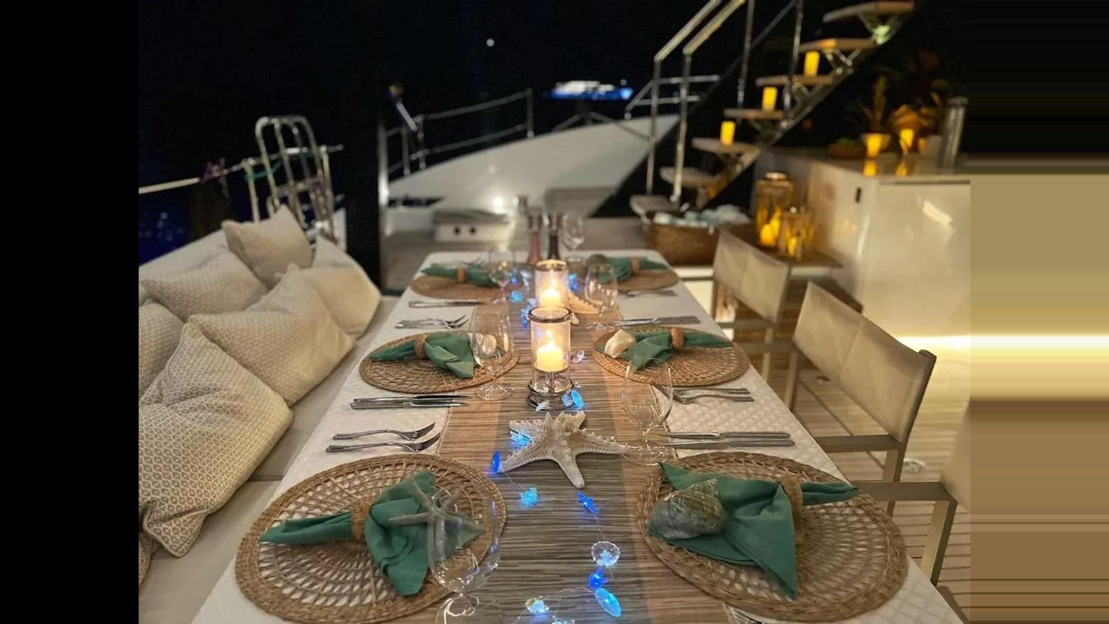 a table with plates and candles aboard SEACLUSION Yacht for Sale