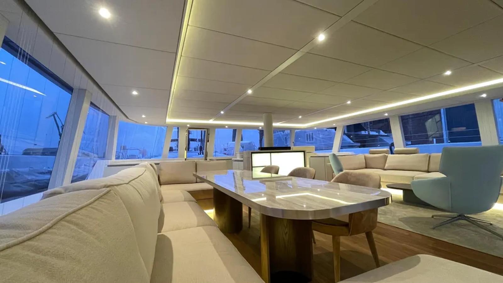 a room with a table and couches aboard SEACLUSION Yacht for Sale