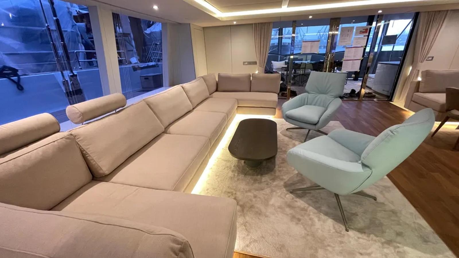 a living room with a couch and a table aboard SEACLUSION Yacht for Sale