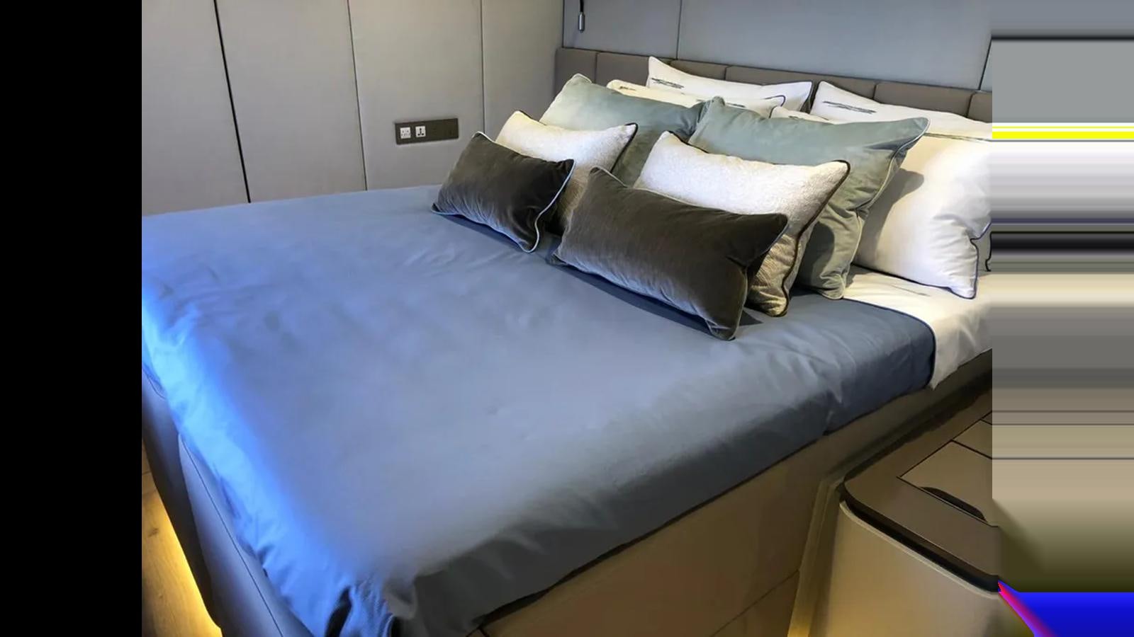 a bed with blue sheets aboard SEACLUSION Yacht for Sale