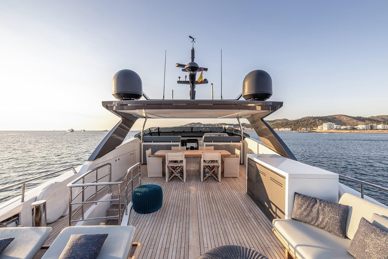 a deck with a large ship on it and a small island with chairs and a table with a aboard COBANA Yacht for Sale