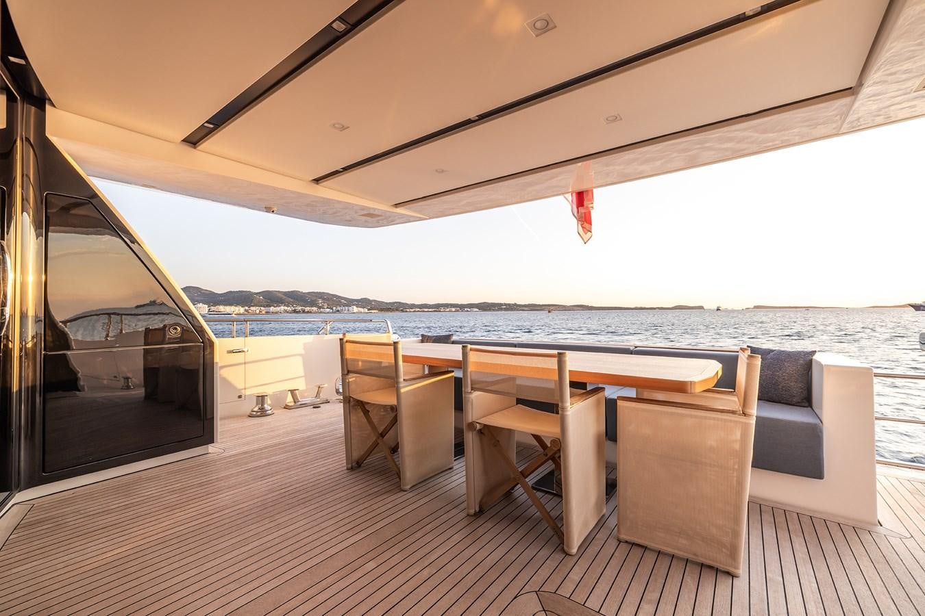 a table and chairs on a deck aboard COBANA Yacht for Sale