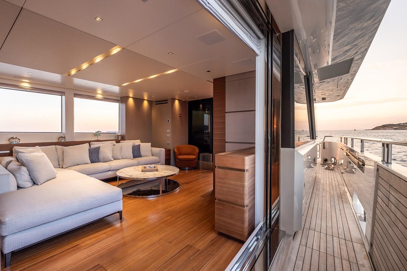 a living room with a large wood floor aboard COBANA Yacht for Sale