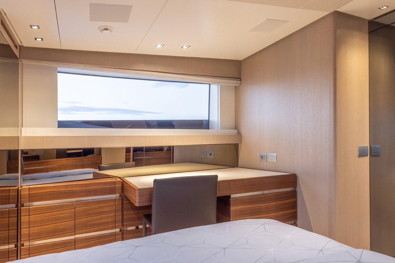 a room with a bed and a tv on the wall aboard COBANA Yacht for Sale