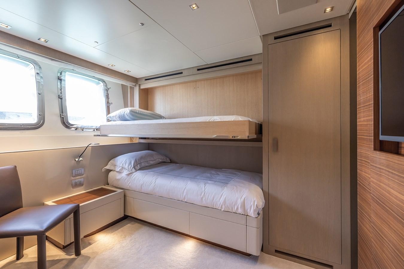 a room with a bed and a chair aboard COBANA Yacht for Sale
