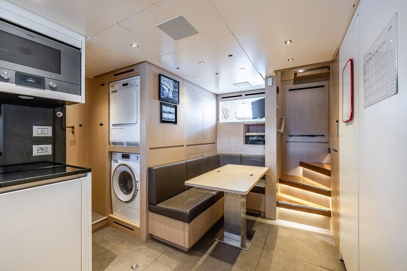 a kitchen with a table and microwave aboard COBANA Yacht for Sale