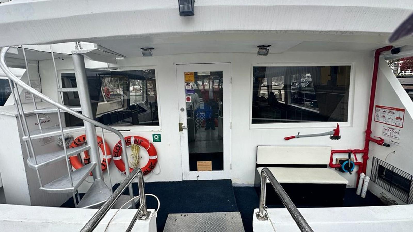 a room with a ladder and a window aboard 1990 PALMER MARINE 68 Yacht for Sale