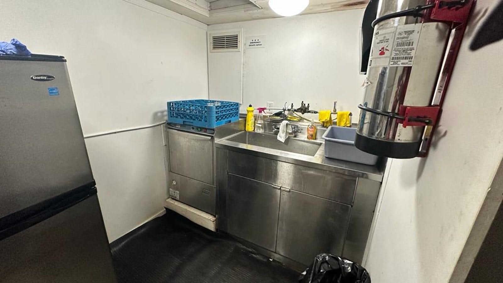 a kitchen with stainless steel appliances aboard 1990 PALMER MARINE 68 Yacht for Sale