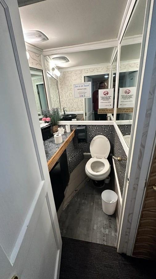 a toilet in a bathroom aboard 1990 PALMER MARINE 68 Yacht for Sale