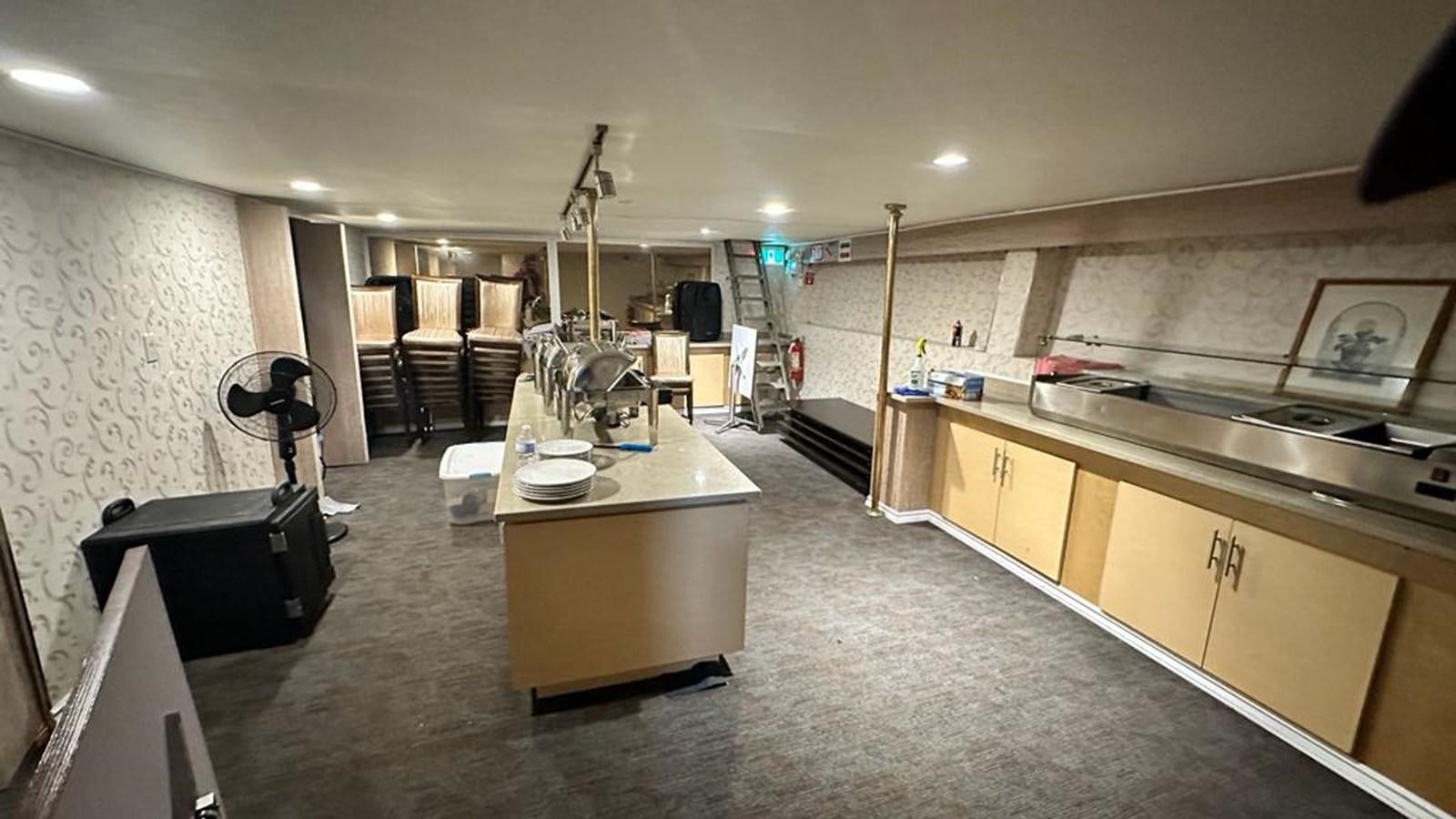 a large kitchen with a large island aboard 1990 PALMER MARINE 68 Yacht for Sale