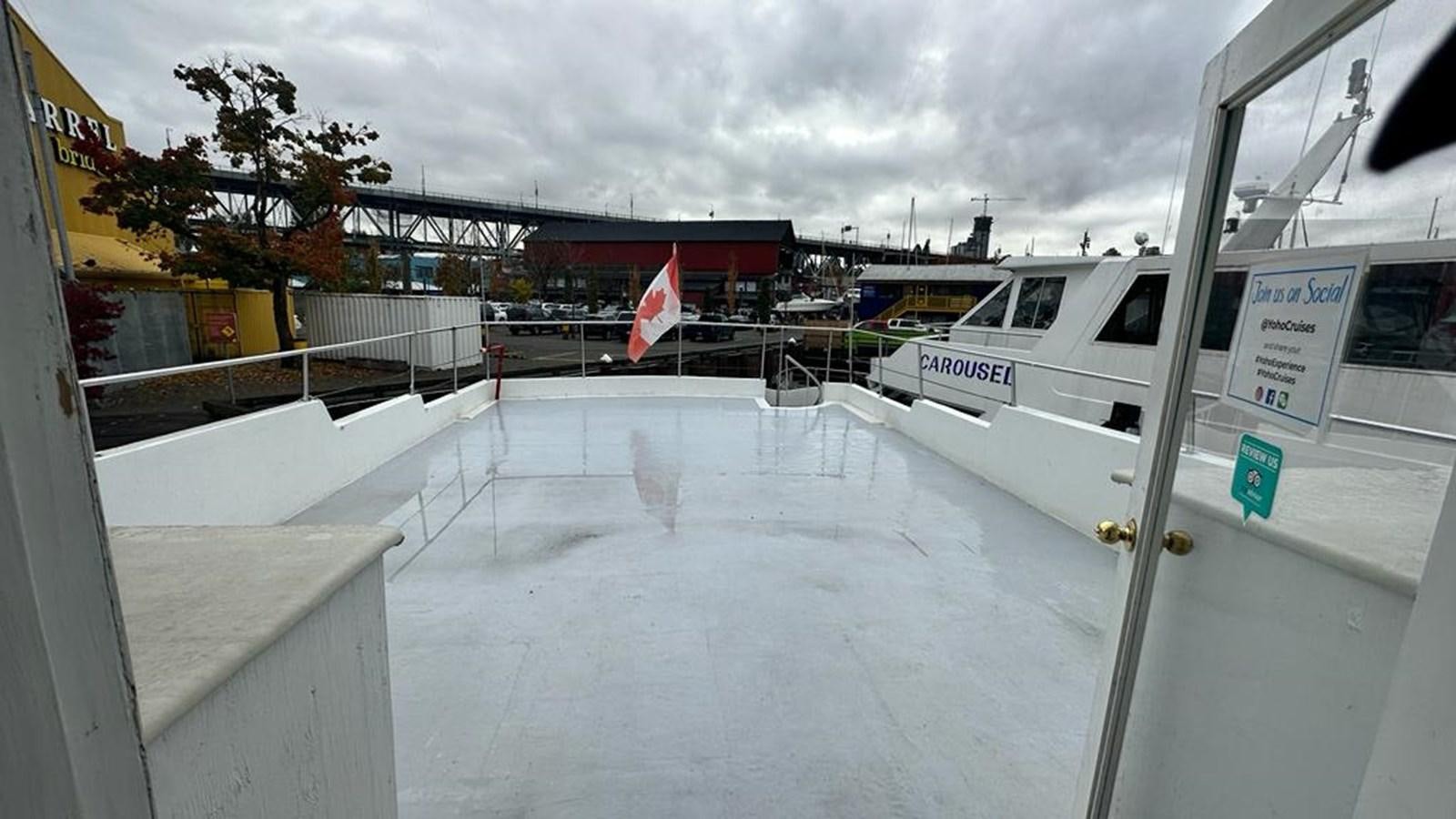 a white car parked in a parking lot aboard 1990 PALMER MARINE 68 Yacht for Sale
