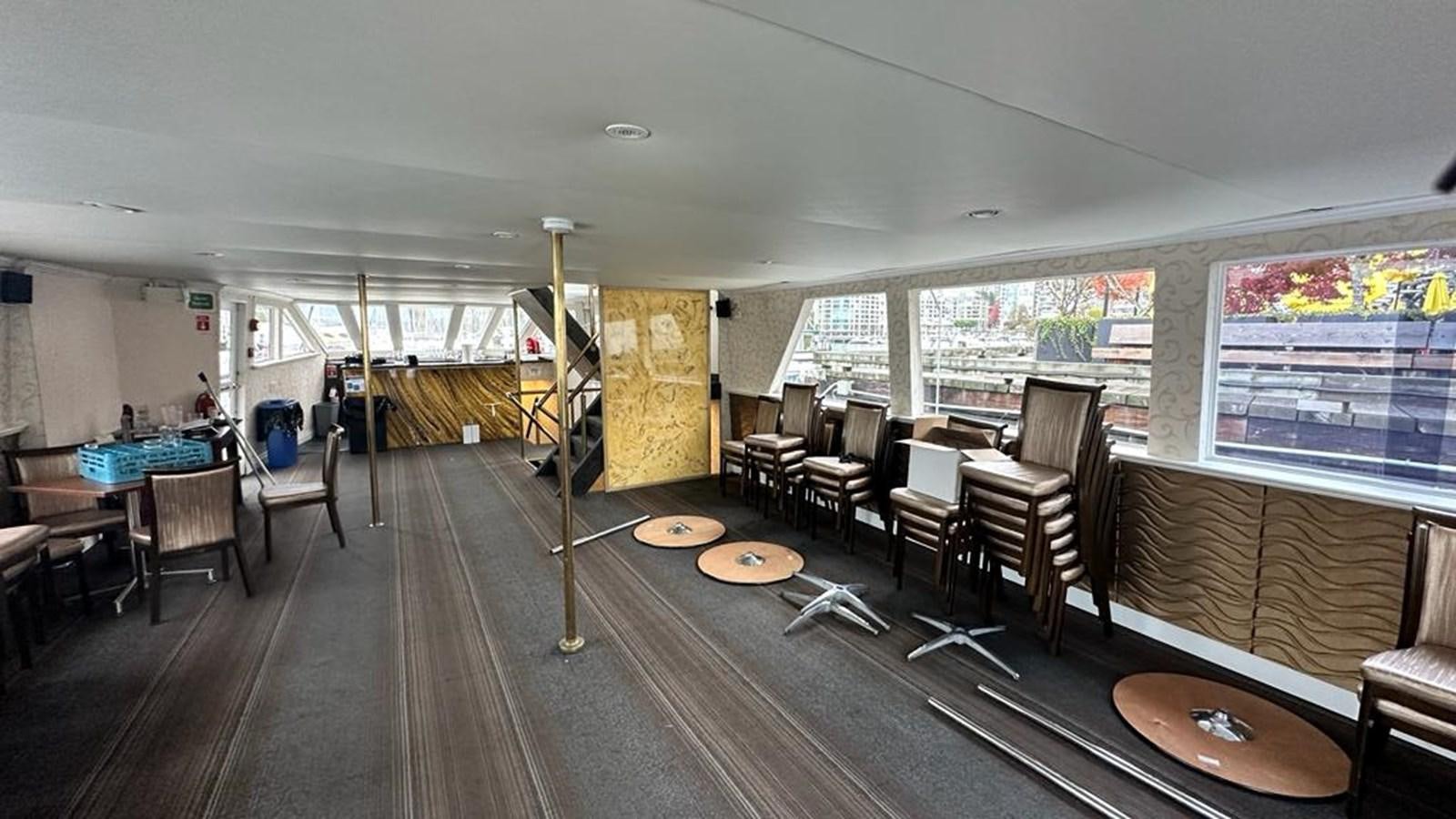 a large room with tables and chairs aboard 1990 PALMER MARINE 68 Yacht for Sale