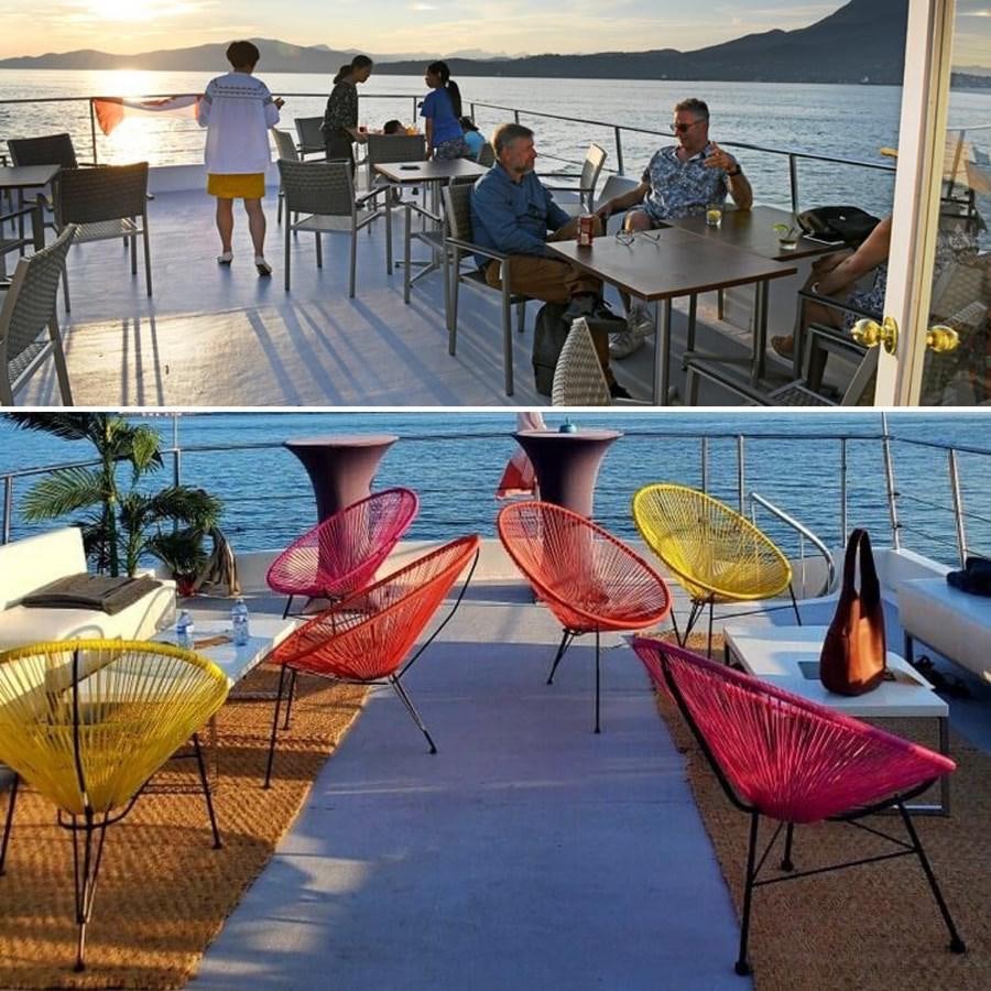 people sitting at tables outside aboard 1990 PALMER MARINE 68 Yacht for Sale