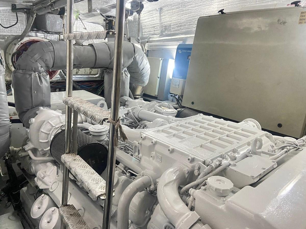 a factory worker working on a machine aboard AUGUST MOON Yacht for Sale