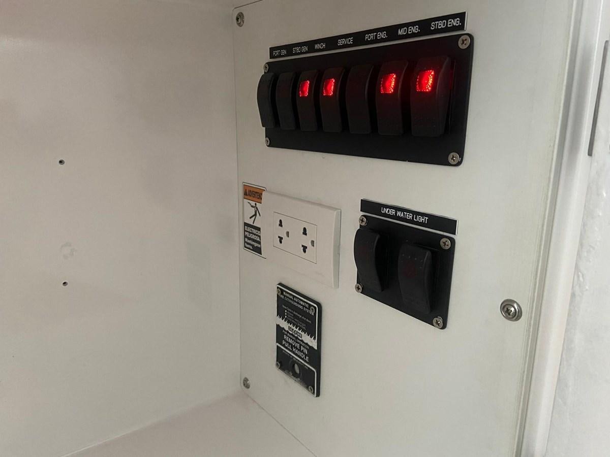 a white wall with a black rectangular object with red lights aboard AUGUST MOON Yacht for Sale