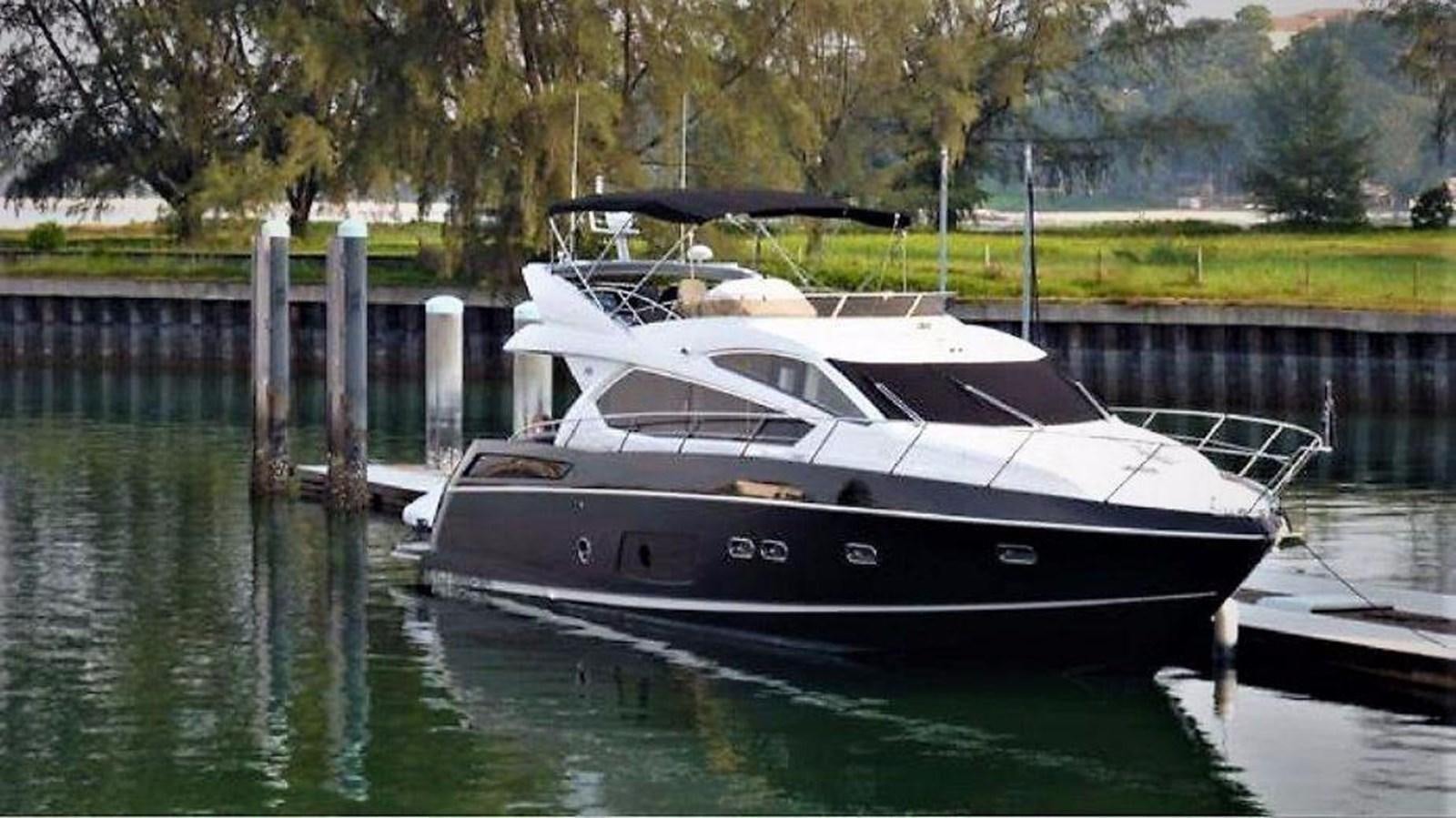 a boat docked at a pier aboard 2012 SUNSEEKER MANHATTAN 63 Yacht for Sale
