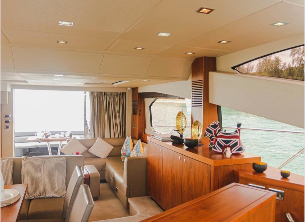 a living room with a couch and a television aboard 2012 SUNSEEKER MANHATTAN 63 Yacht for Sale